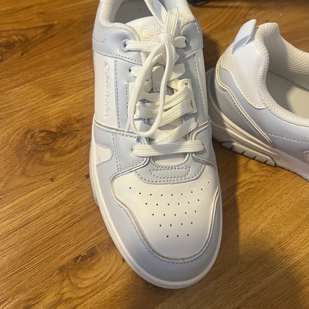 Brand new sneakers. Calvin Klein.  Never worn.  Great for jeans or shorts!